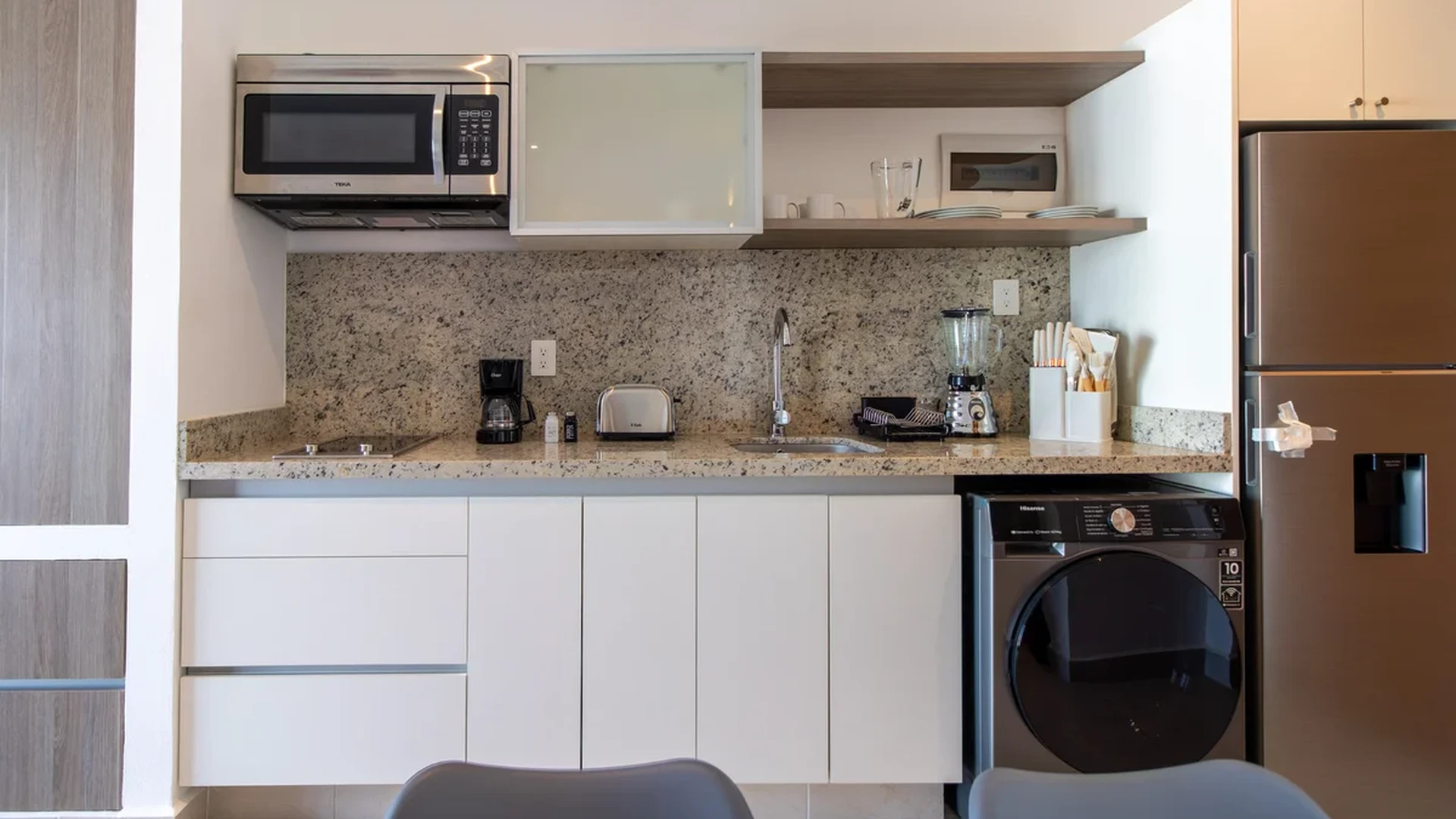 View of Kitchenette at Nativo, showcasing Modern Kitchen, Stainless Steel Appliances.