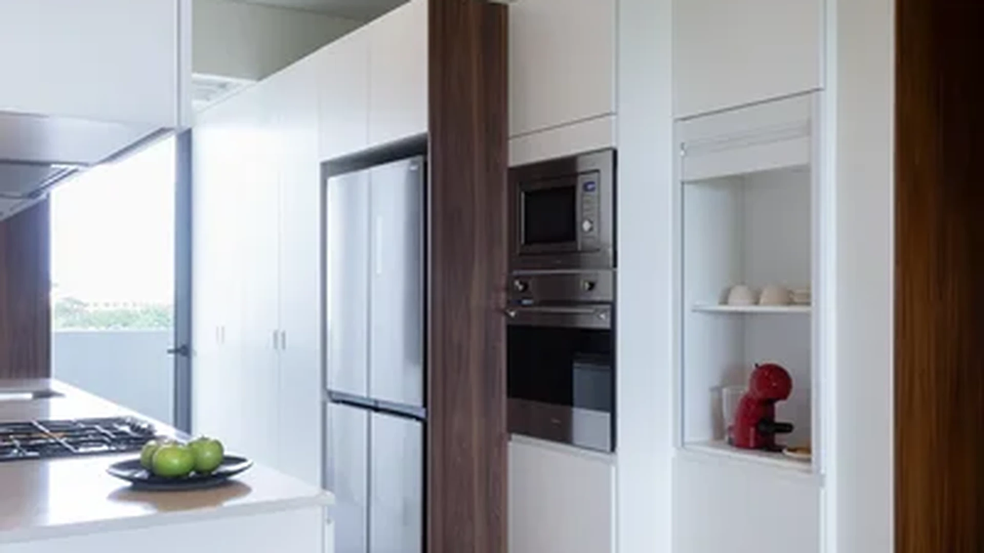 View of Modern Kitchen at Woha, showcasing Gourmet Kitchen, Stainless Steel Appliances.
