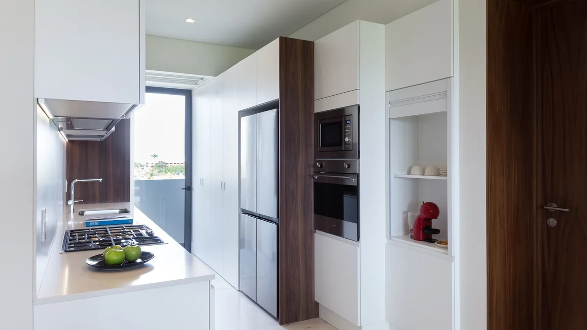 View of Modern Kitchen at Woha, showcasing White Cabinetry, Stainless Steel Appliances.