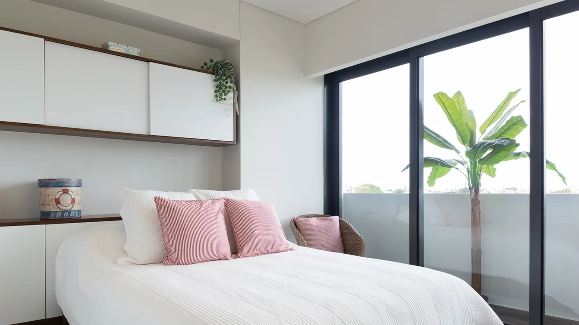 View of Bedroom at Woha, showcasing Natural Light, Built-in Storage.