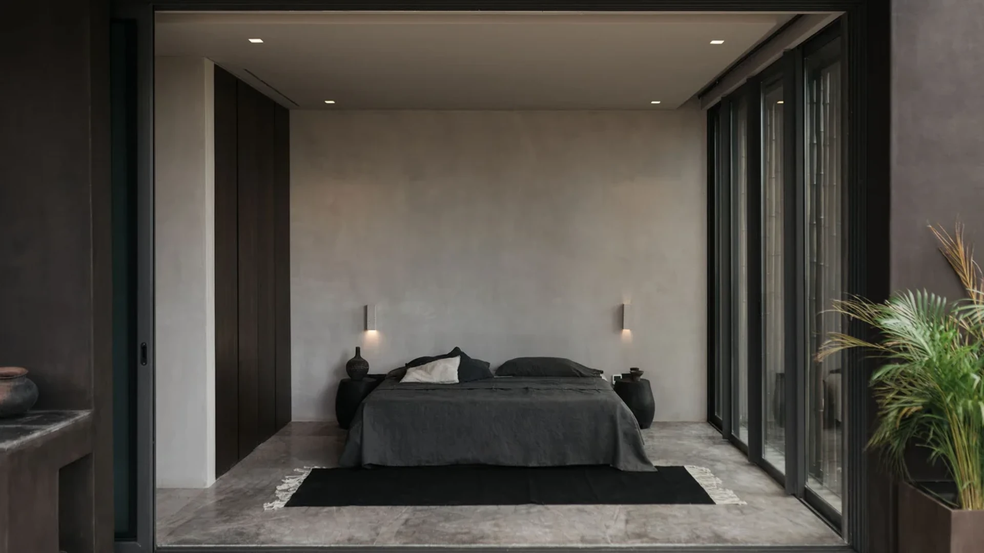 View of Minimalist Bedroom at La Reserva, showcasing Modern Design, Concrete Floors.