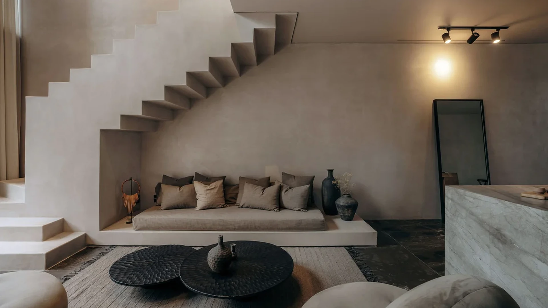 View of Minimalist Living Room at La Reserva, showcasing Architectural Staircase, Modern Interior Design.