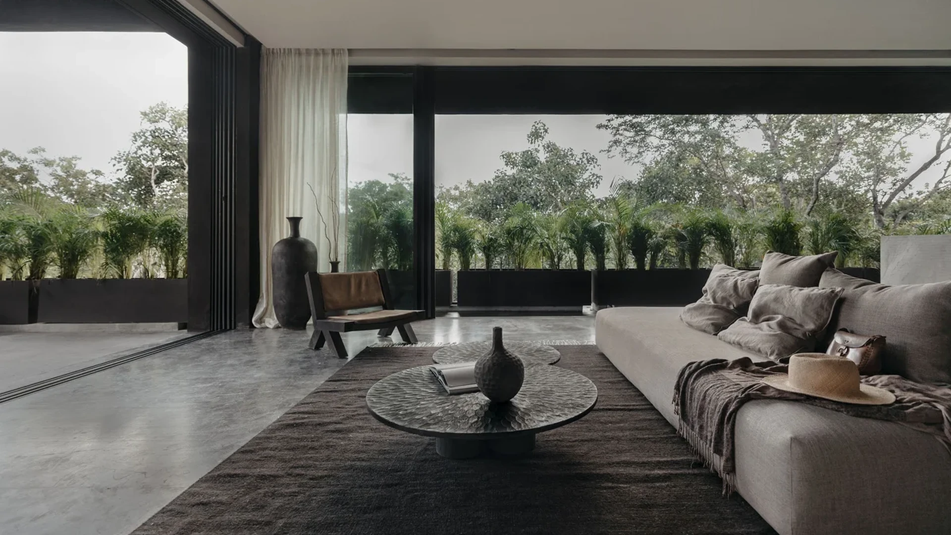 View of Modern Living Room at La Reserva, showcasing Indoor-Outdoor Living, Floor-to-Ceiling Windows.