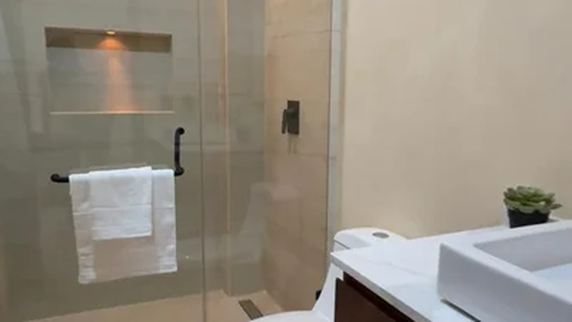 View of Modern Bathroom at Alux 33, showcasing Walk-in Shower, Rainfall Shower Head.