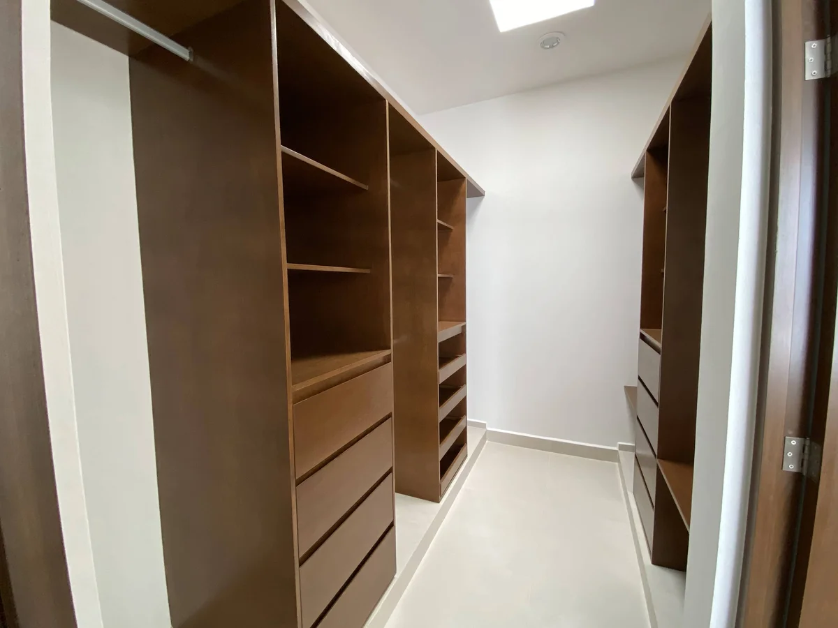 View of Walk-in Closet at Palmara, showcasing Custom Cabinetry, Wood Shelving.