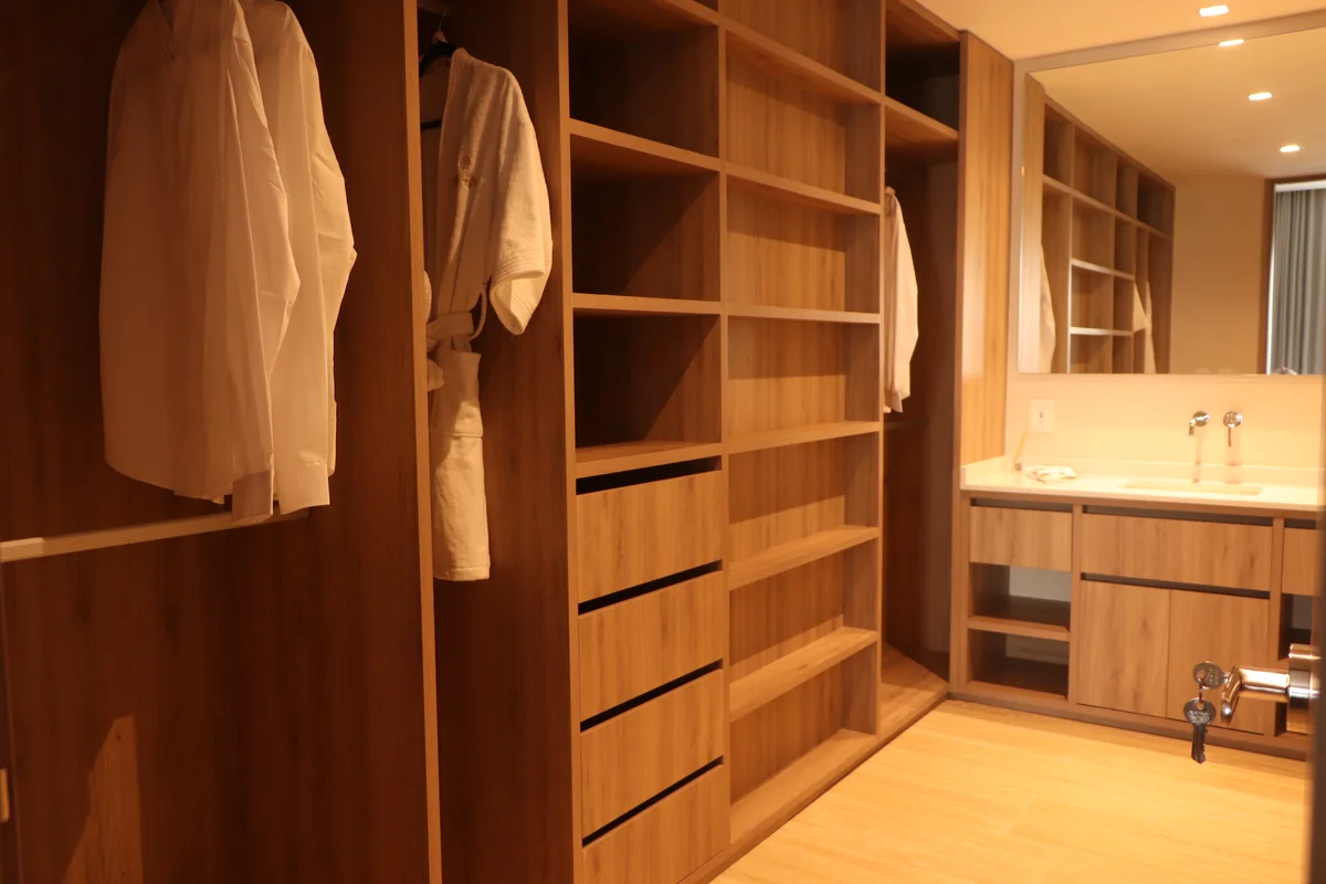 View of Walk-In Closet at Hodela, showcasing Custom Cabinetry, Dressing Room.