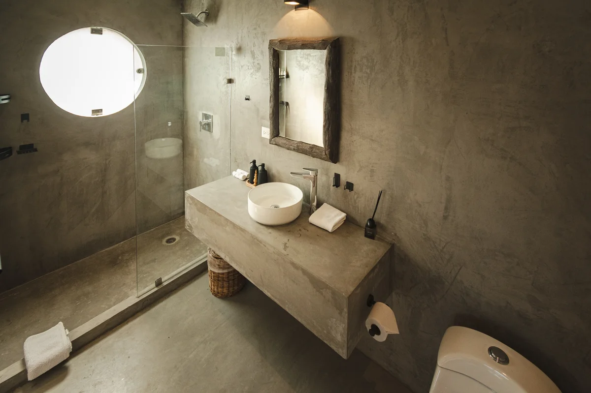 View of Modern Bathroom at Gold Garden, showcasing Concrete Finish, Walk-in Shower.