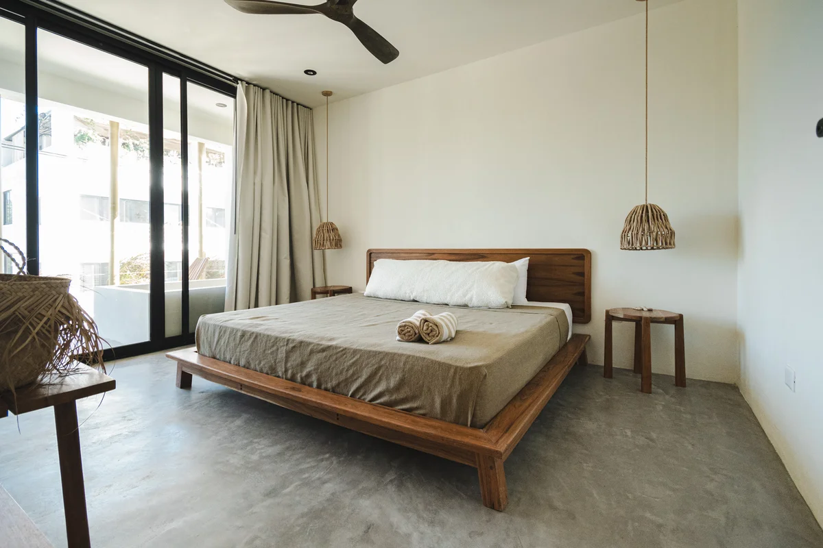 View of Minimalist Bedroom at Gold Garden, showcasing Modern Design, Concrete Flooring.