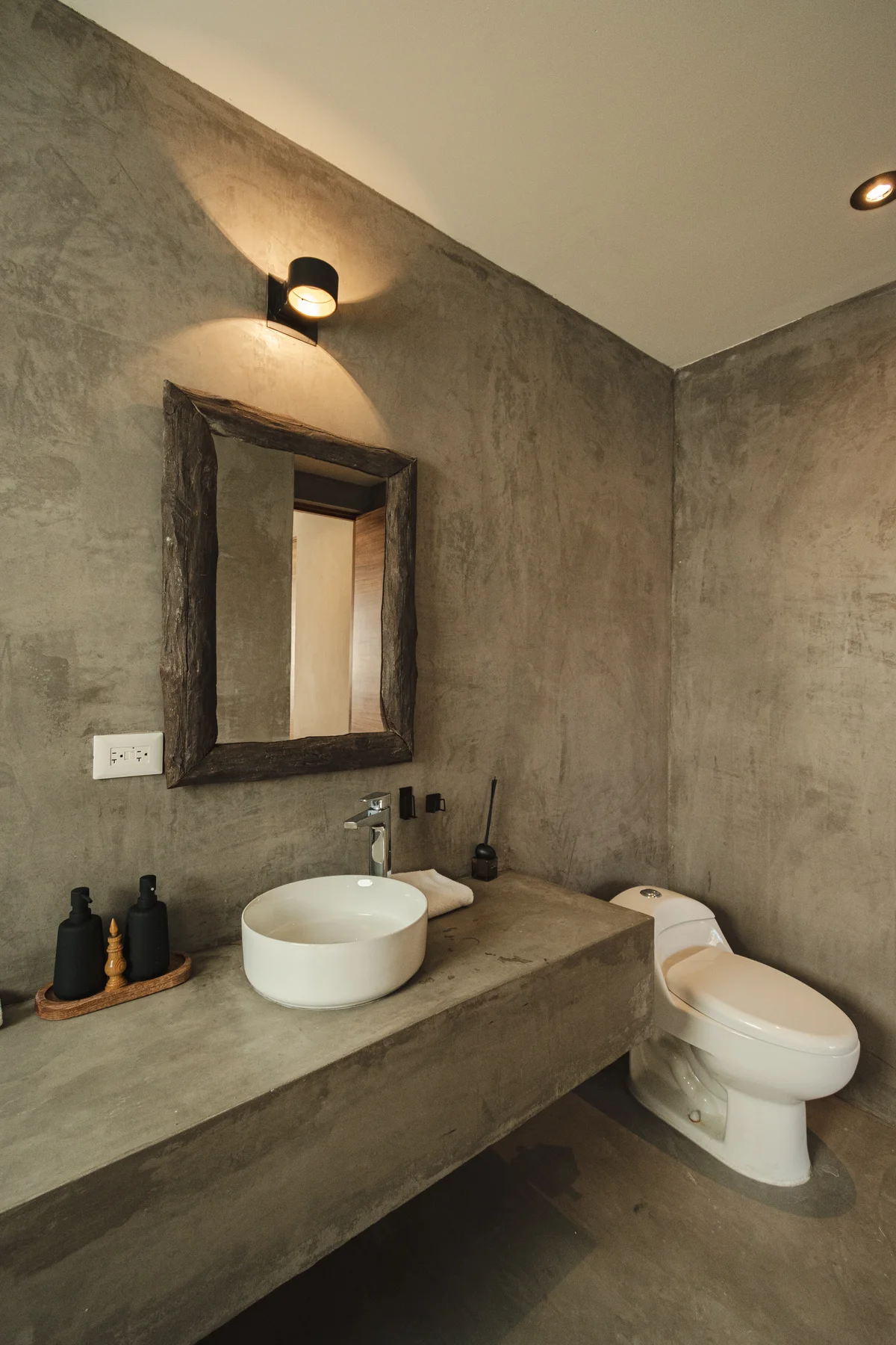 View of Modern Bathroom at Gold Garden, showcasing Industrial Design, Concrete Walls.