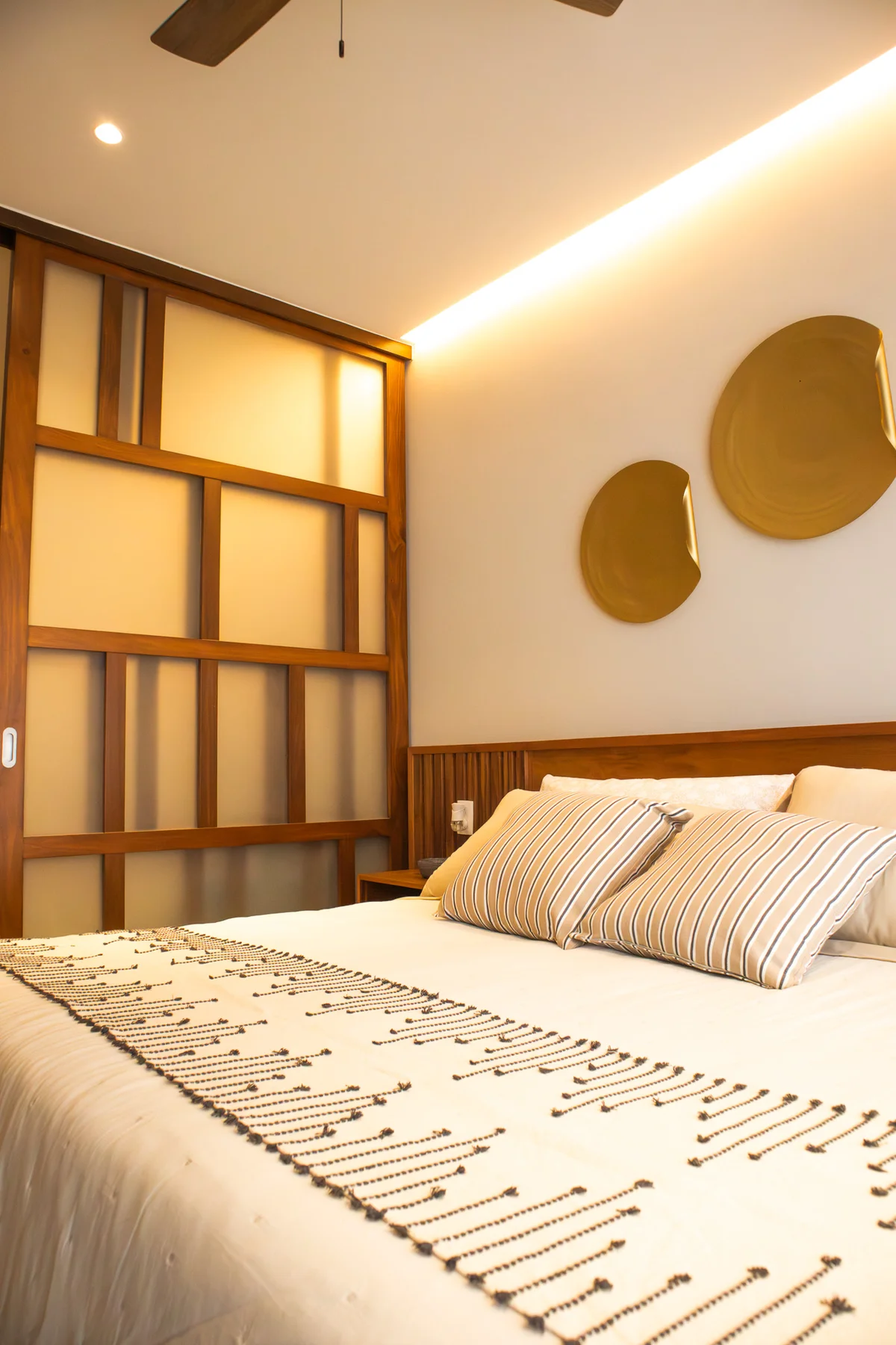 View of Modern Bedroom at Ikuku, showcasing Wood Accents, Designer Headboard.