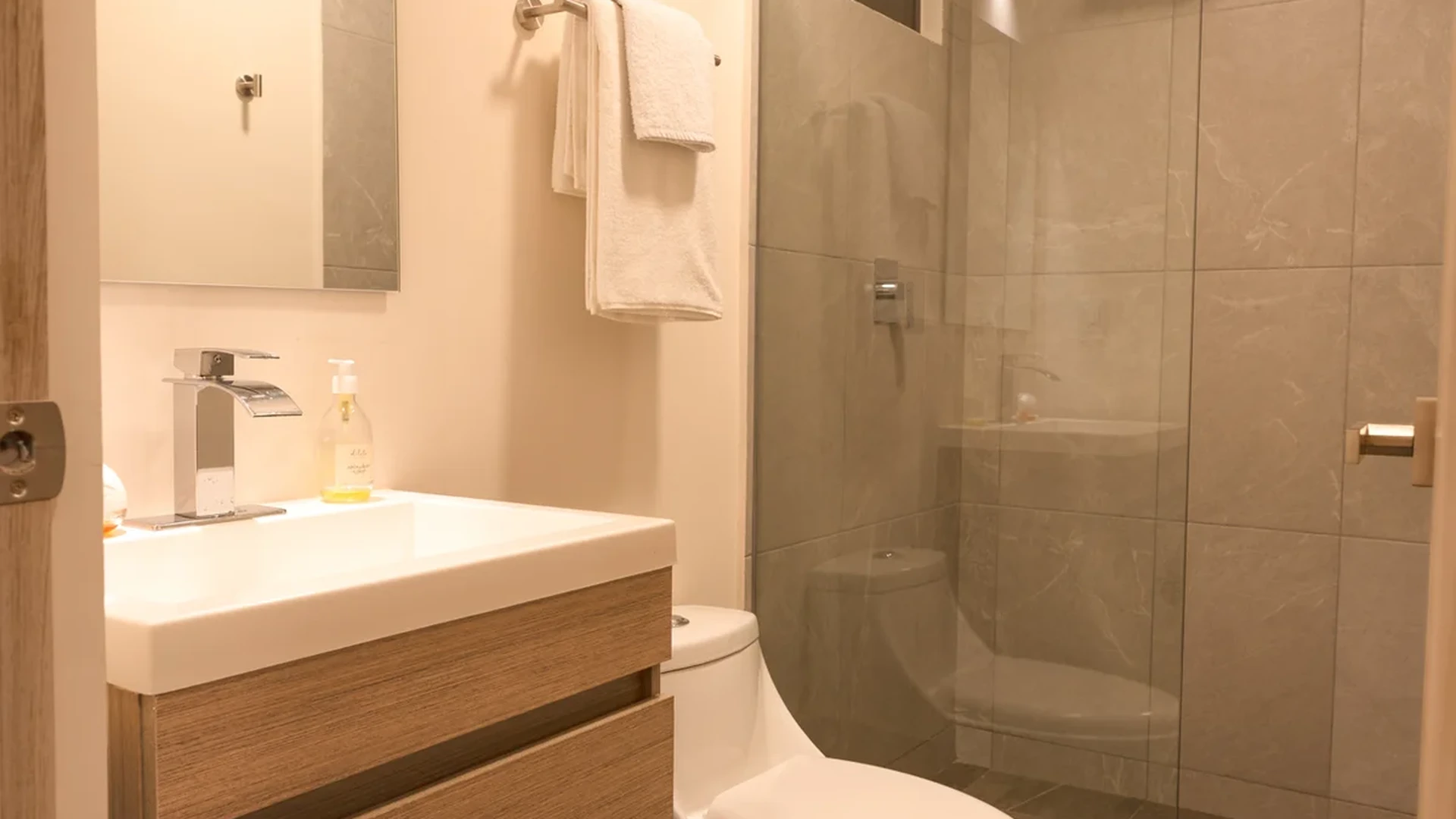 View of Modern Bathroom at Wamai, showcasing Walk-in Shower, Glass Shower Door.
