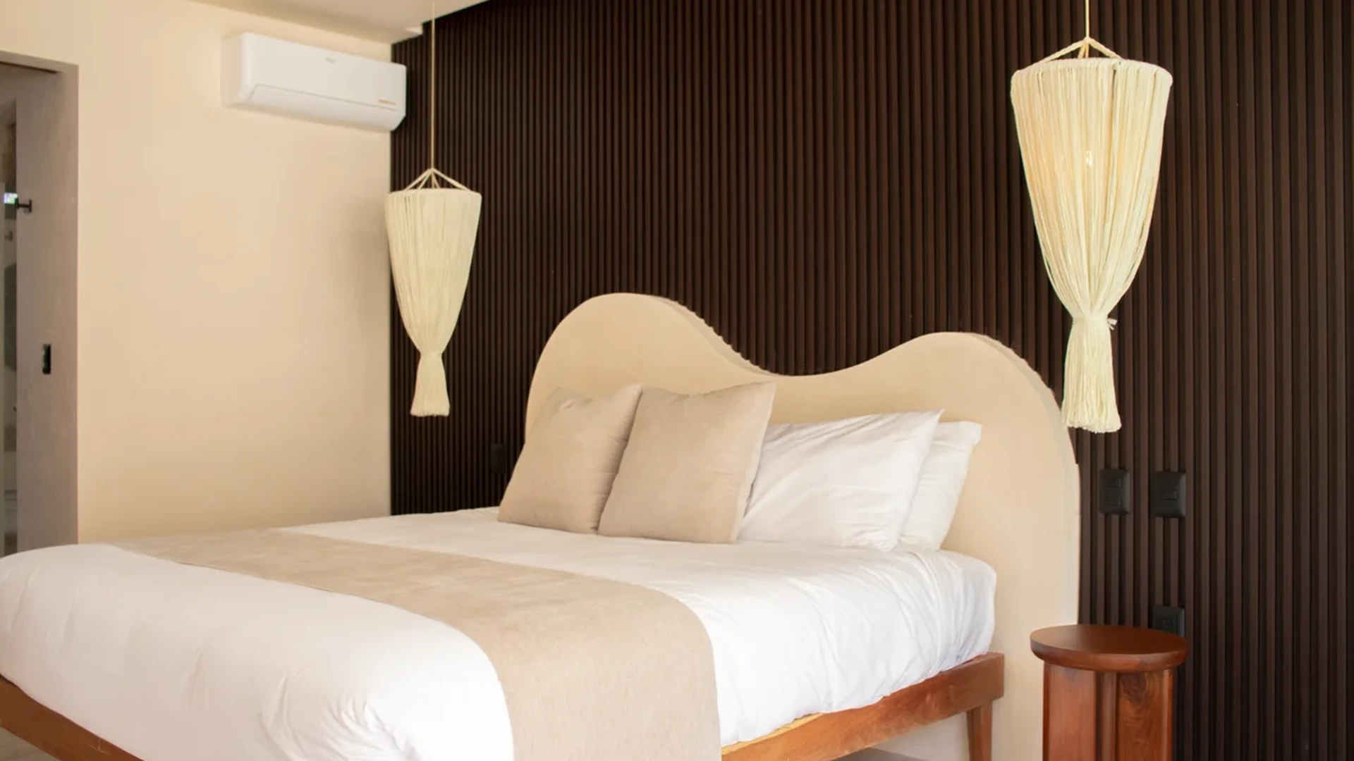 View of Modern Bedroom at Loch, showcasing Textured Accent Wall, Designer Headboard.