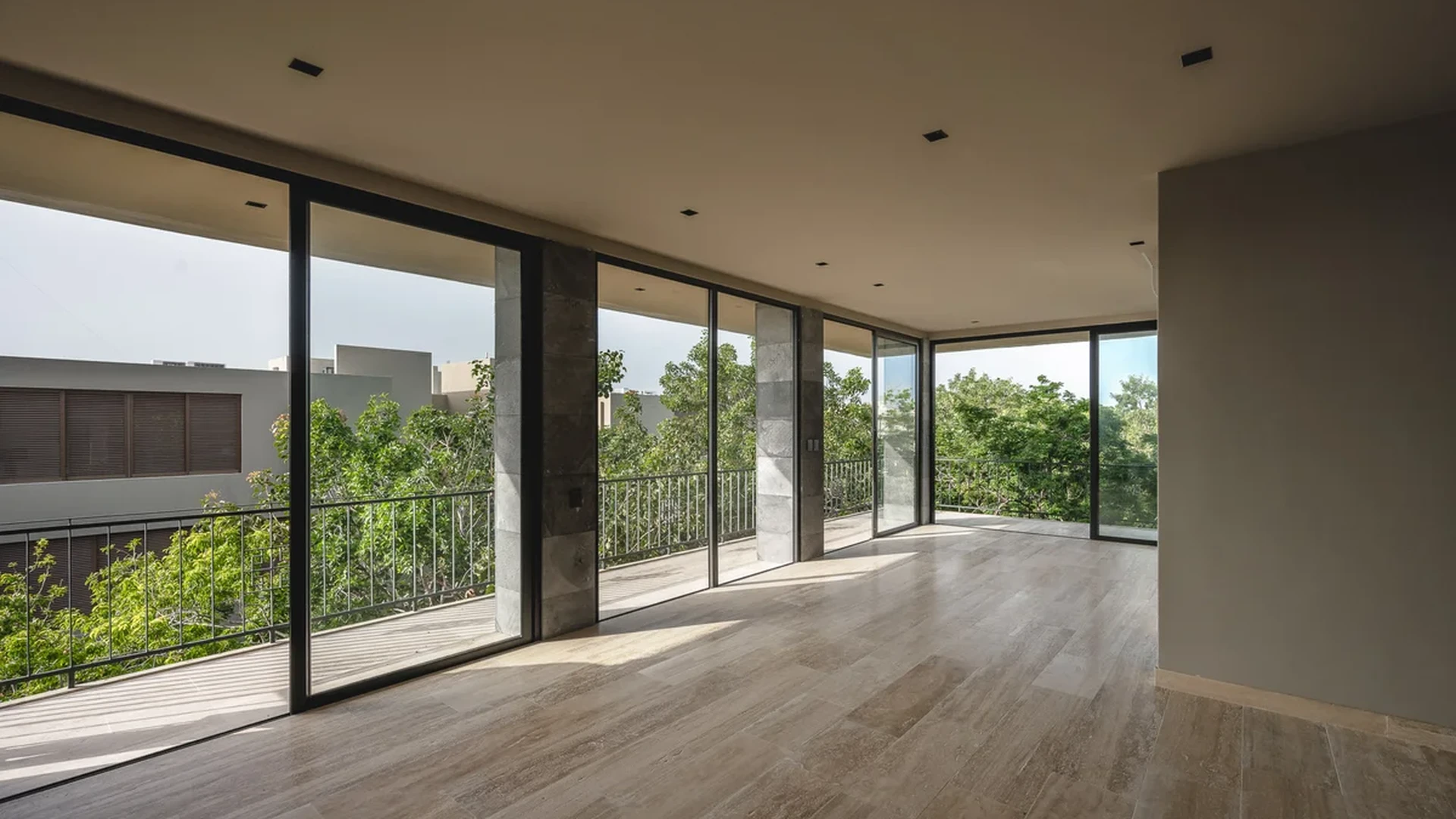 View of Spacious Living Area at Arthouse, showcasing Floor-to-Ceiling Windows, Natural Light.