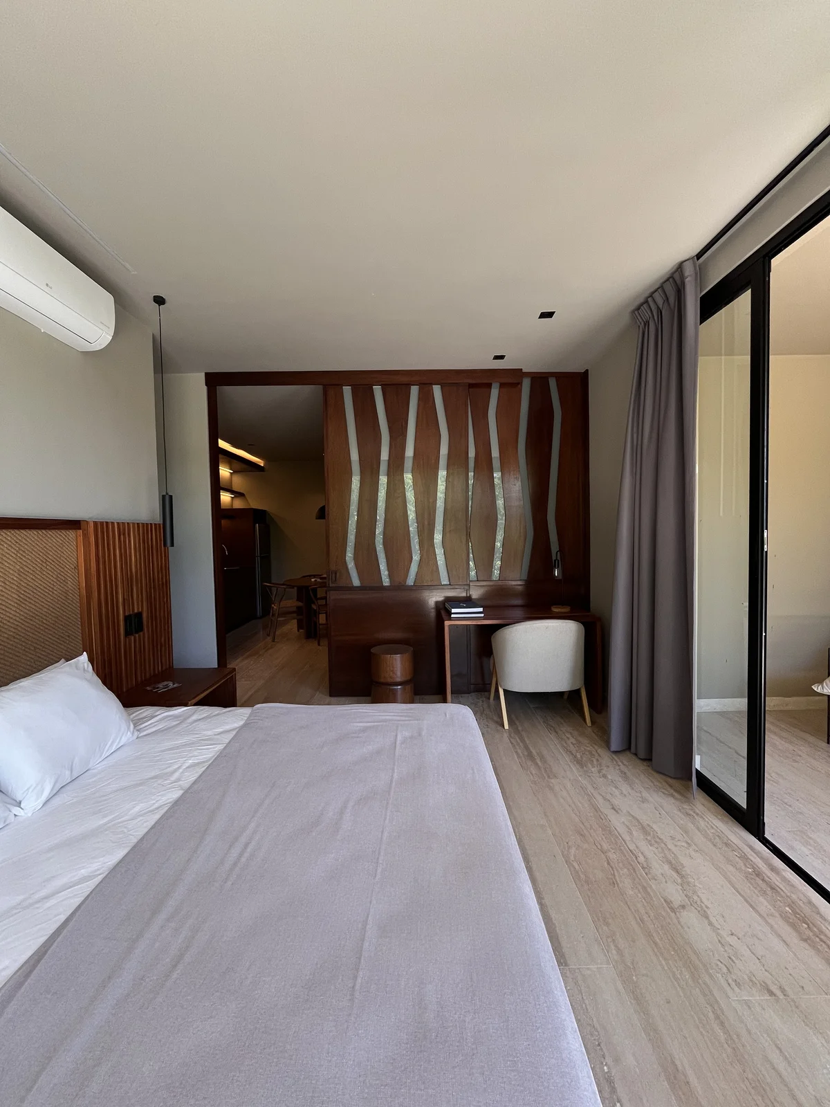 View of Modern Bedroom at Arthouse, showcasing Wood Accent Wall, Built-in Desk.