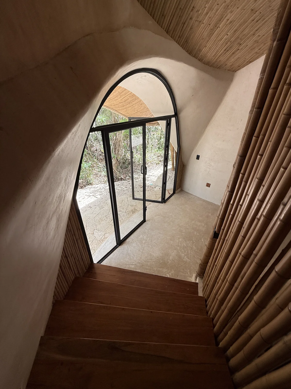 View of Unique Architecture at Green Dream, showcasing Bamboo Walls, Wooden Staircase.