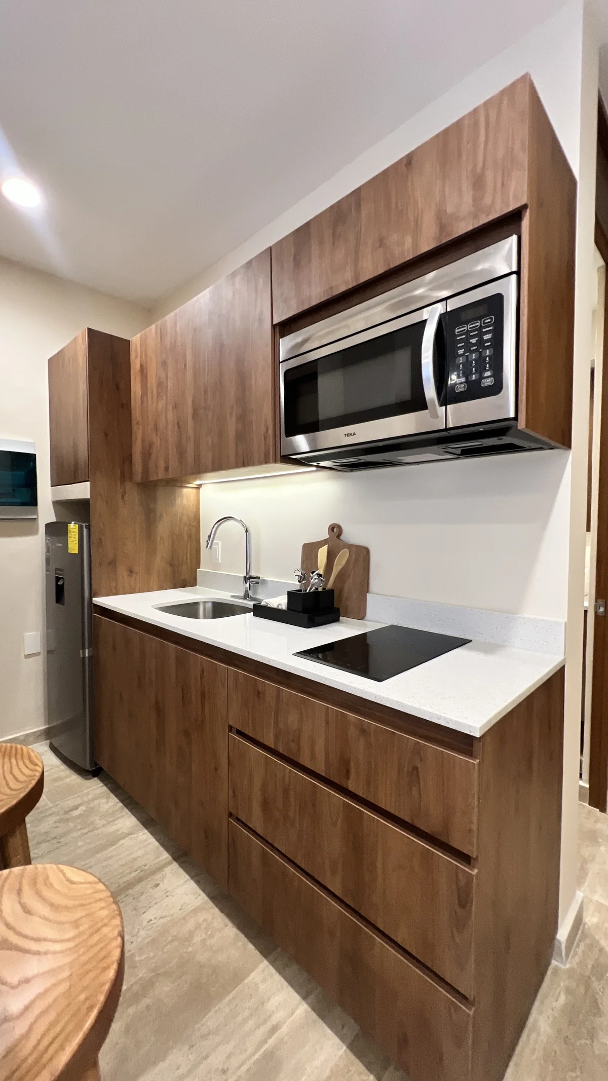 View of Modern Kitchenette at Constelada, showcasing Compact Kitchen, Wood Cabinetry.