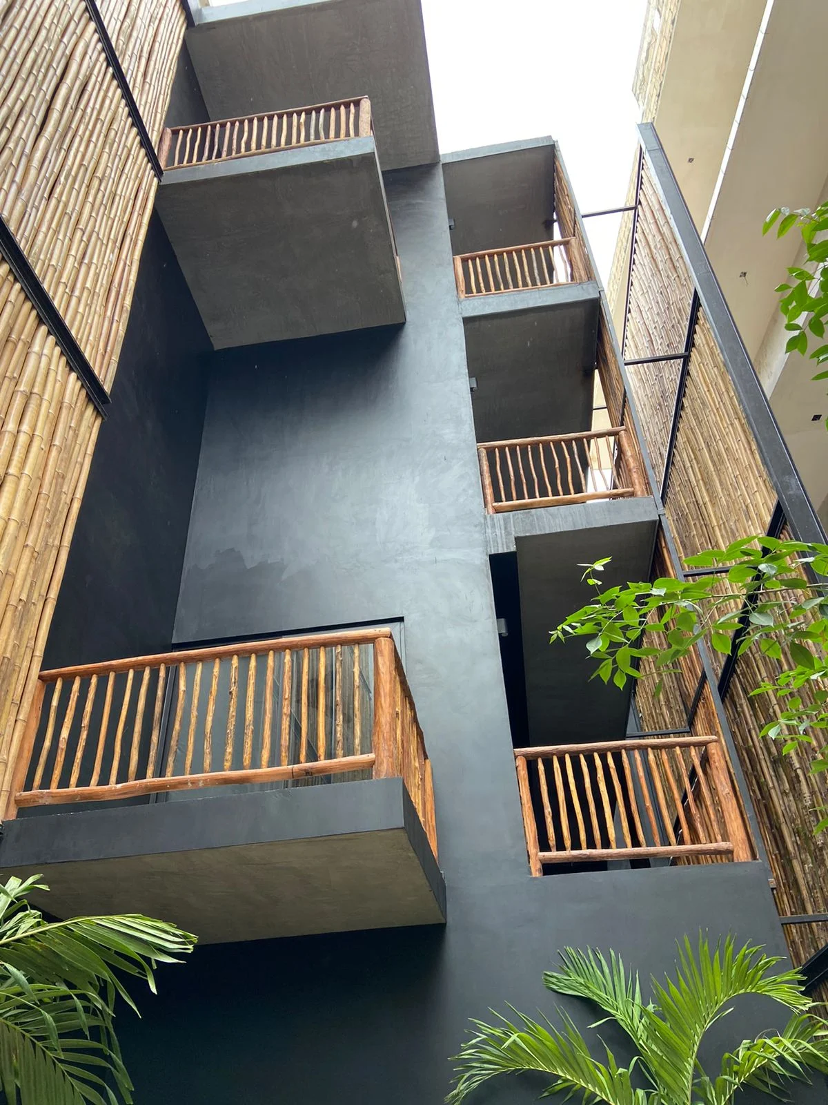 View of Modern Architecture at Hoja Santa, showcasing Rustic Balconies, Bamboo Siding.