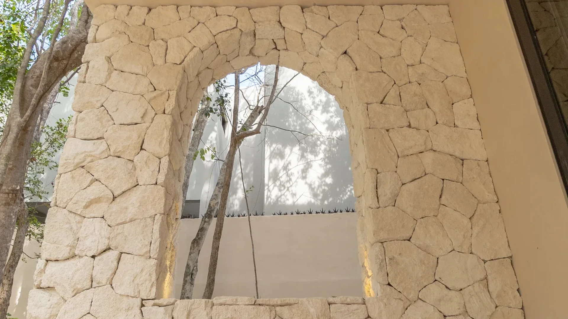 Image of Garden at Villas INMOVA, featuring Covered Patio, Stone Accent Wall.