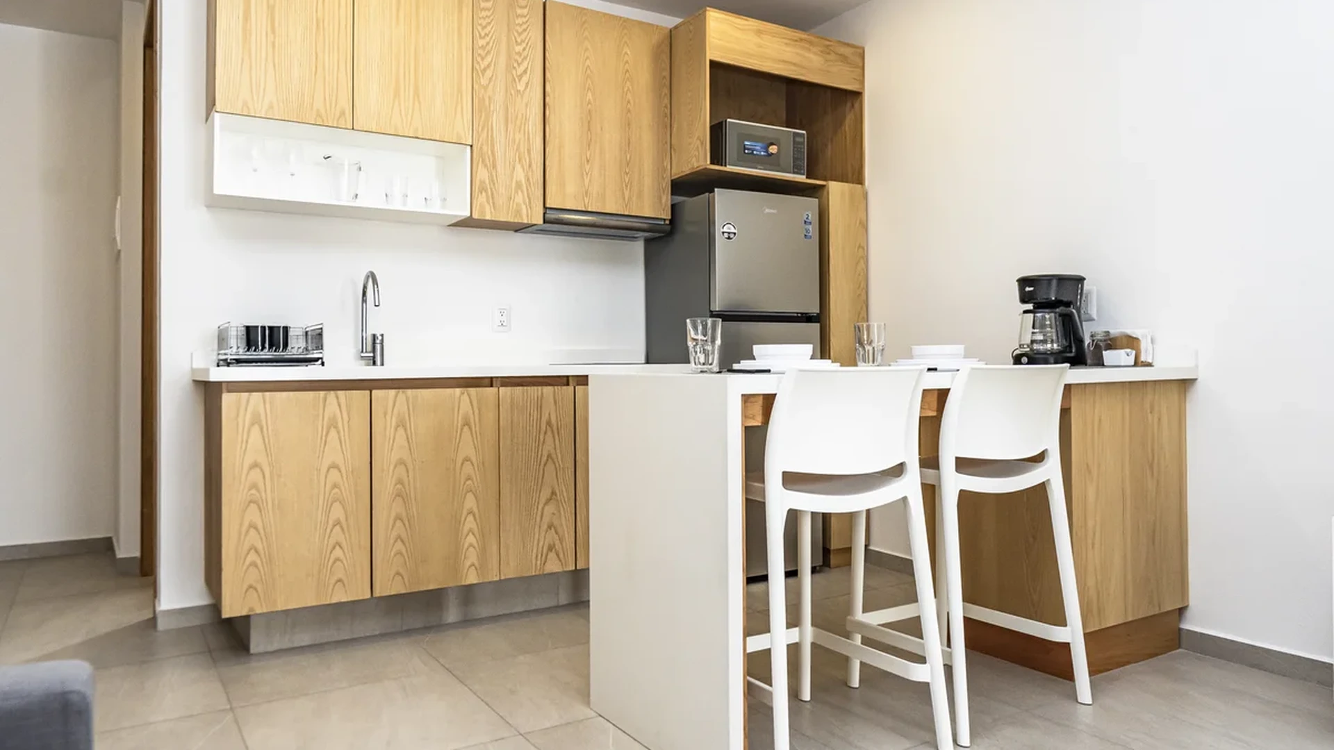 View of Modern Kitchenette at Levitat 20, showcasing Light Wood Cabinets, Breakfast Bar.