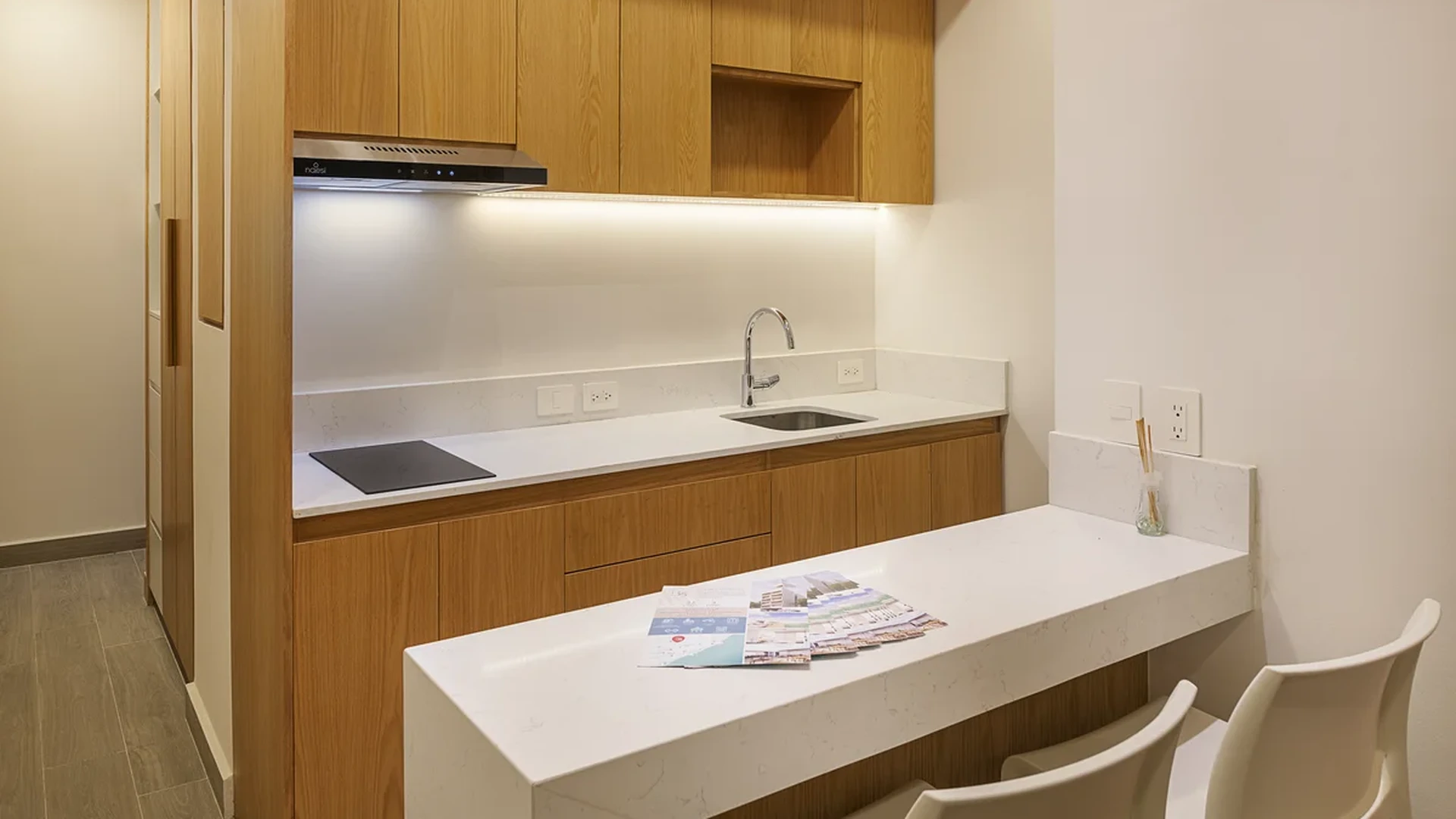 View of Kitchenette at Le 35 Residences, showcasing Modern Kitchen, Wood Cabinetry.