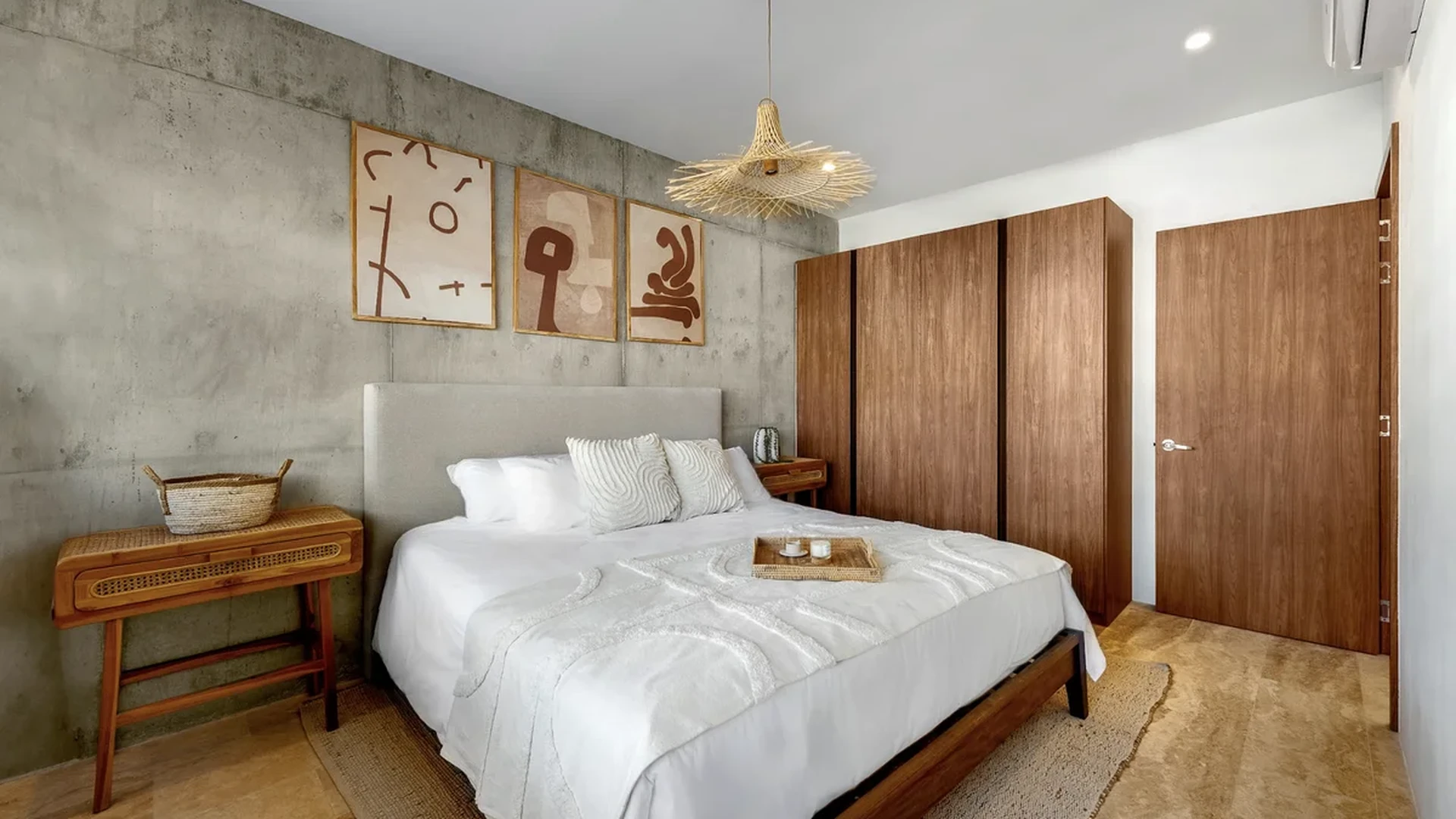 View of Modern Bedroom at BeUTiful, showcasing Concrete Accent Wall, Boho Chic Design.