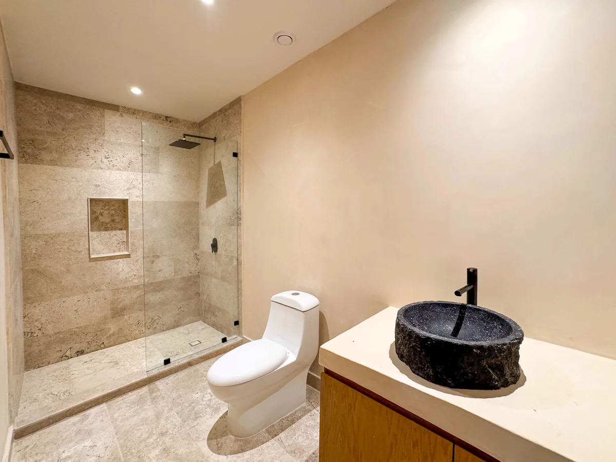 View of Modern Bathroom at Oniric, showcasing Walk-in Shower, Stone Vessel Sink.