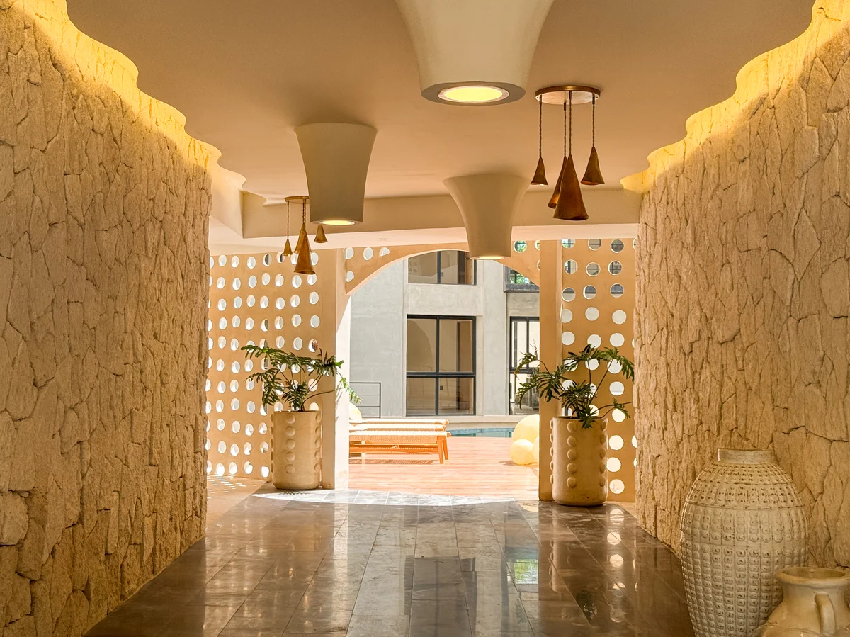 Image of Swimming Pool at Oniric, featuring Architectural Hallway, Stone Wall Design.