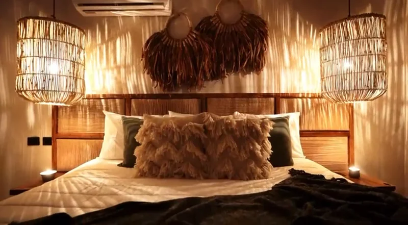 View of Bohemian Bedroom at Tamarindos, showcasing Rustic Interior Design, Woven Pendant Lights.