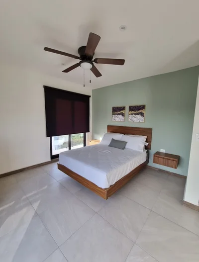View of Modern Bedroom at Mya Black Diamond, showcasing Floating Bed, Tiled Flooring.