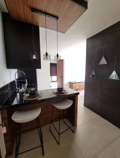 View of Modern Kitchen at Mya Black Diamond, showcasing Kitchen Island, Breakfast Bar.