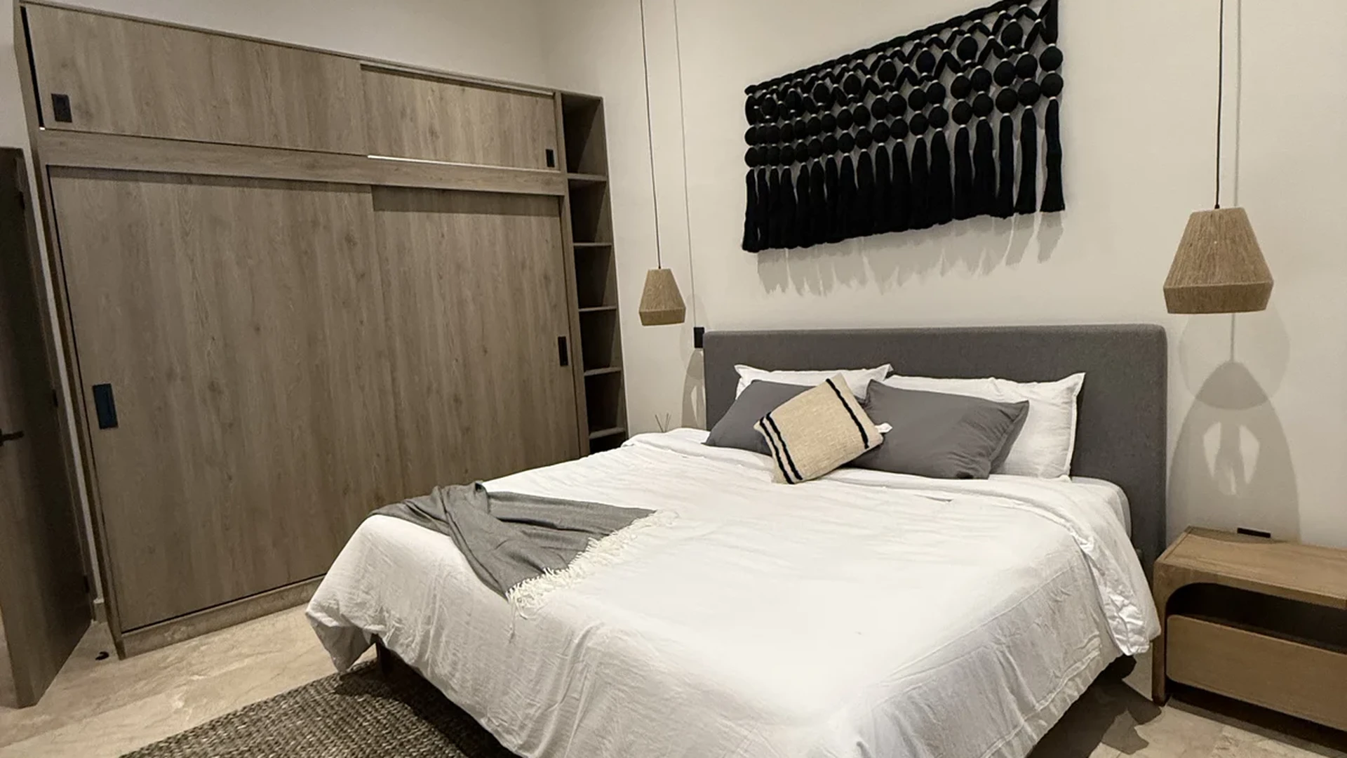 View of Modern Bedroom at iX, showcasing Minimalist Design, Pendant Lighting.