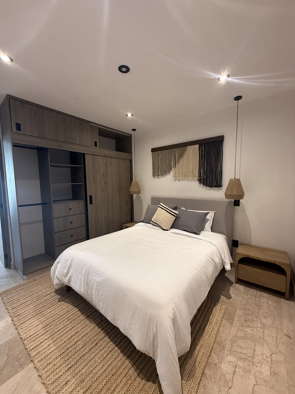 View of Modern Bedroom at iX, showcasing Built-in Closet, Marble Flooring.