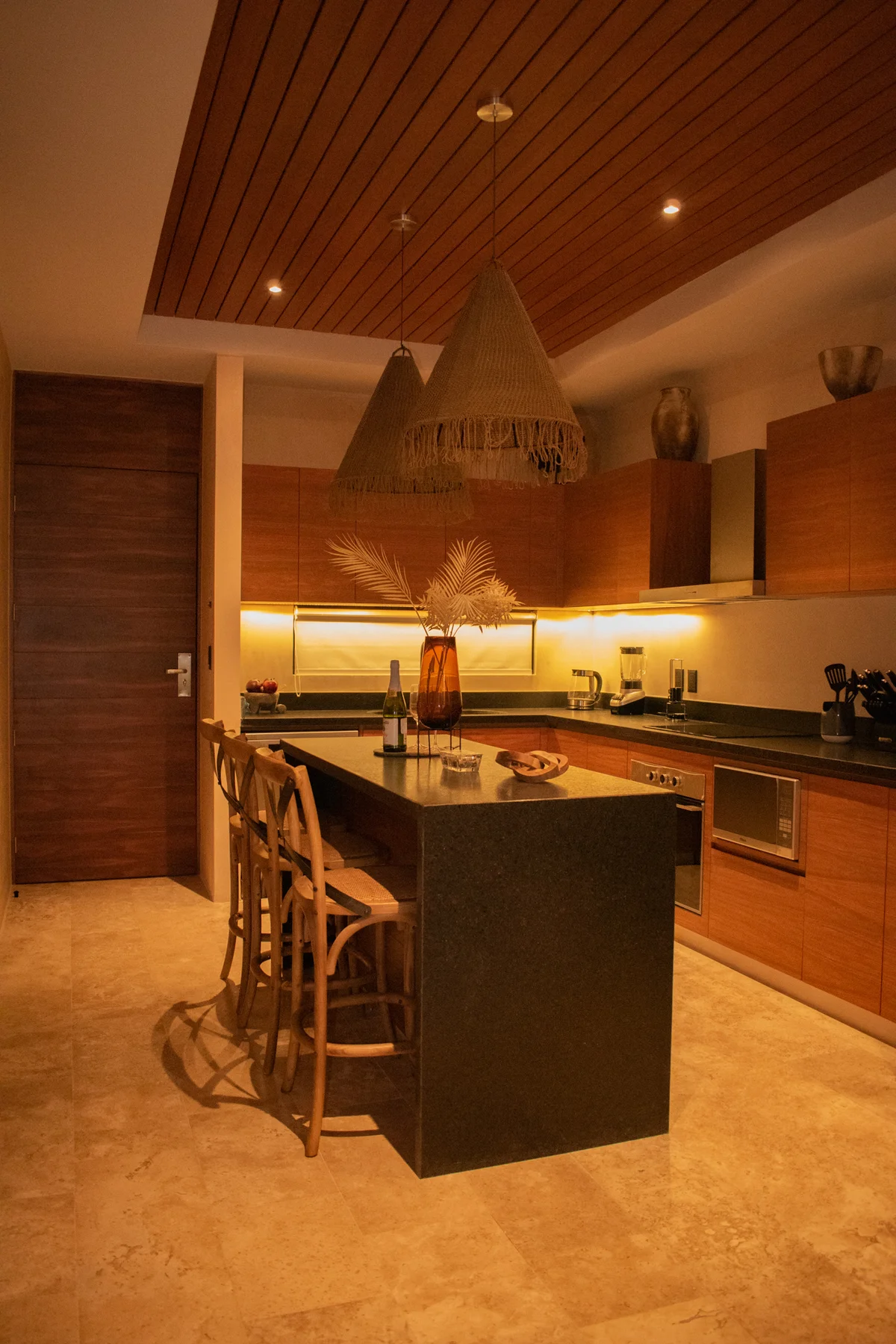 View of Modern Kitchen at Deja Vu, showcasing Kitchen Island, Wood Cabinetry.