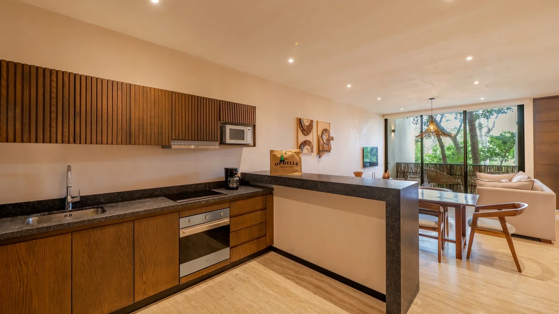 View of Modern Kitchen at Ophelia, showcasing Open Concept Living, Wood Cabinetry.