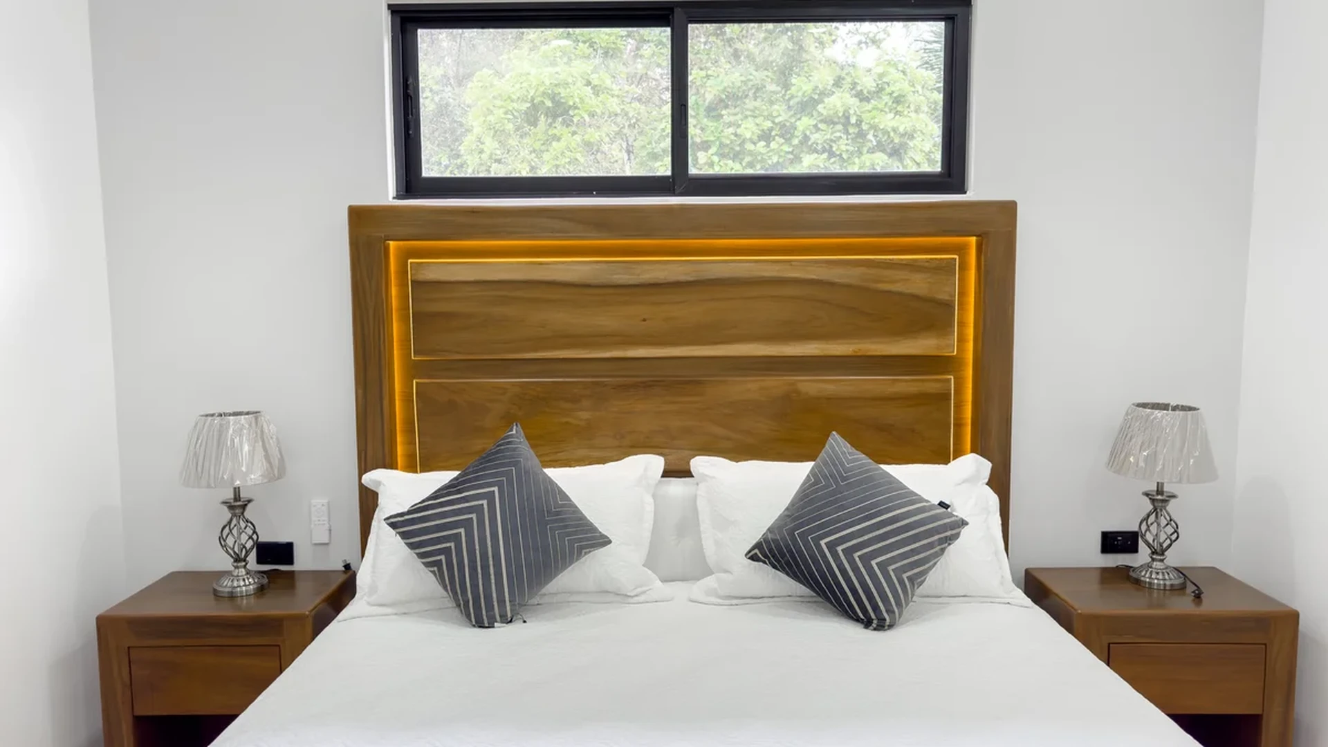 View of Master Bedroom at Blue Water, showcasing Modern Design, Wood Headboard.