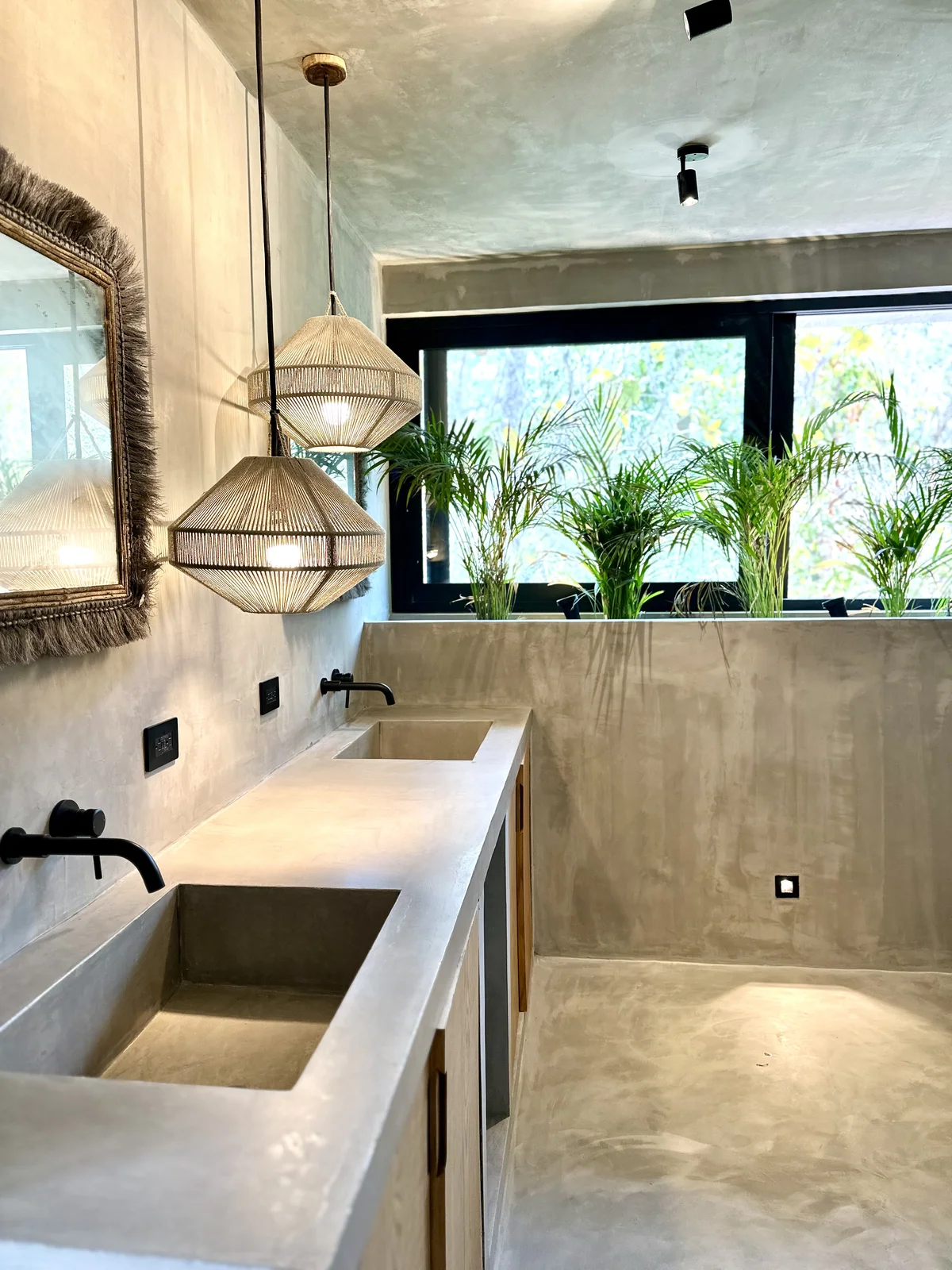 View of Modern Bathroom at Xanbel, showcasing Concrete Vanity, Double Sink.