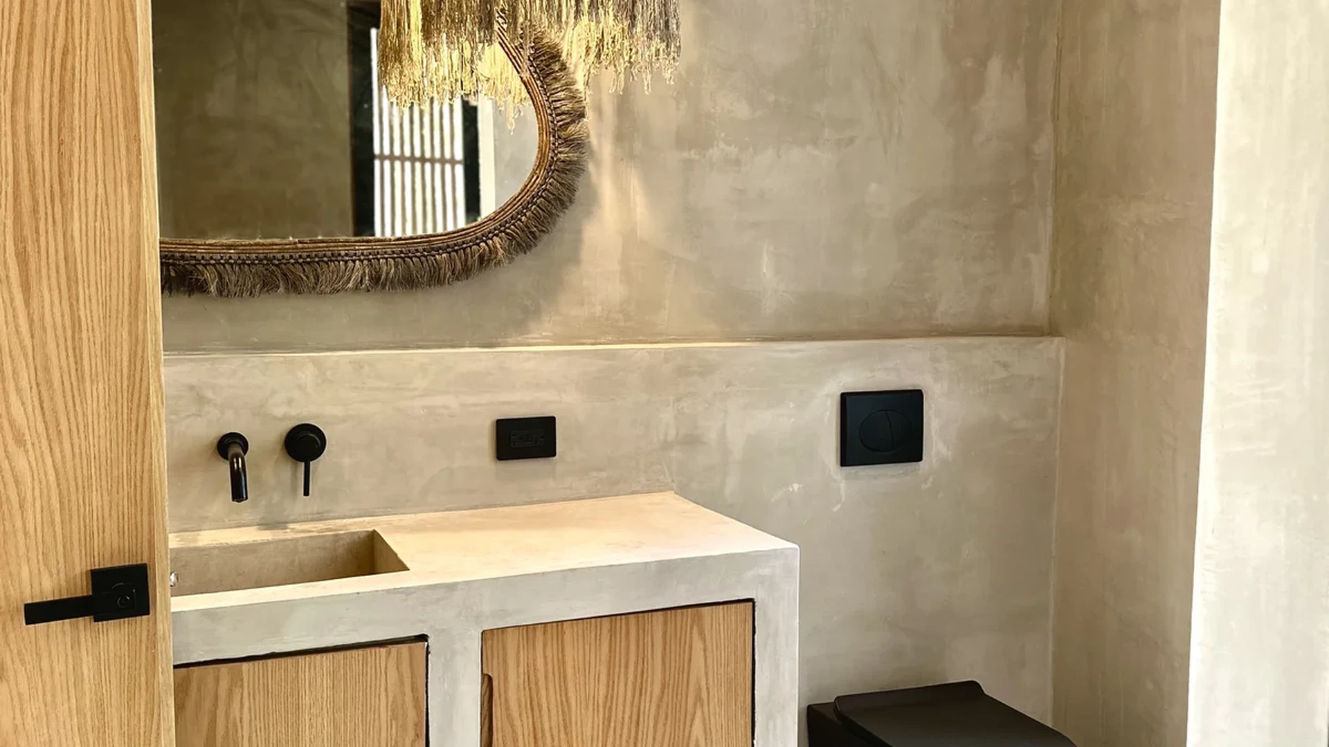 View of Modern Bathroom at Xanbel, showcasing Bohemian Design, Concrete Vanity.