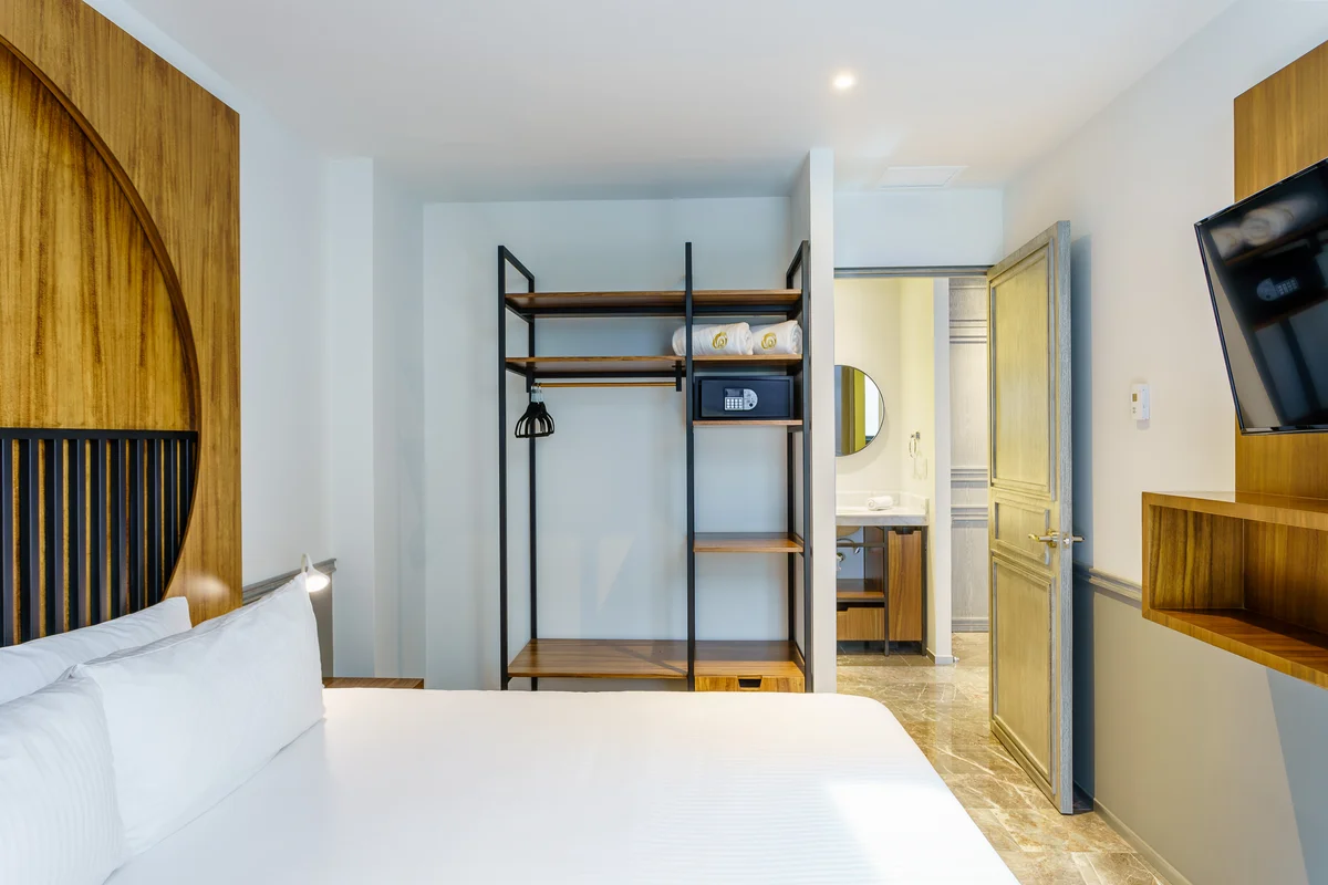 View of Modern Bedroom at Singular Joy, showcasing En-suite Bathroom, Wood Accents.