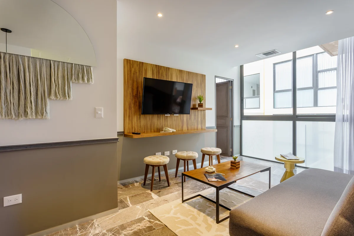 View of Modern Living Room at Singular Joy, showcasing Marble Flooring, Wood Accent Wall.