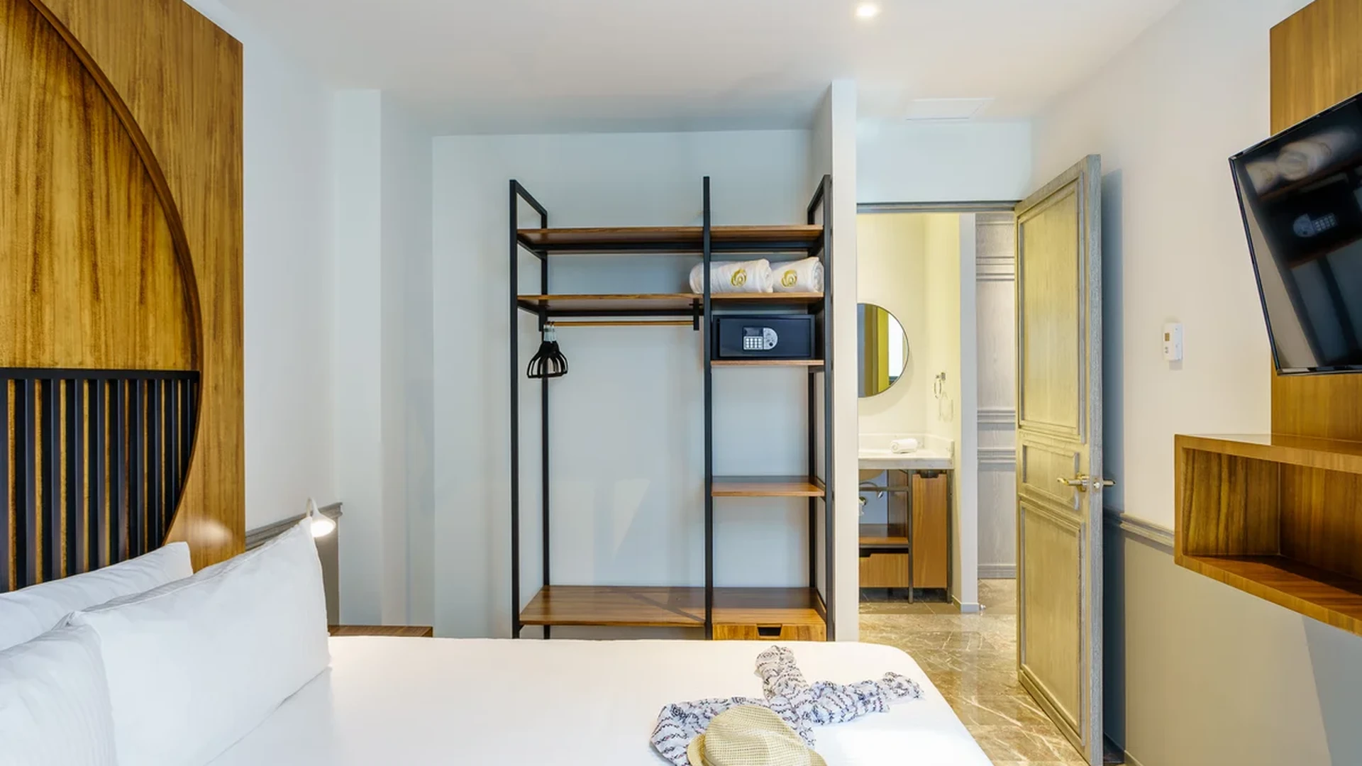 View of Modern Bedroom at Singular Joy, showcasing Hotel Style Room, Wood Accents.