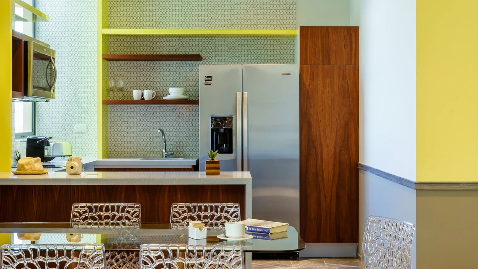 View of Modern Dining Room at Singular Joy, showcasing Open Kitchen, Marble Flooring.