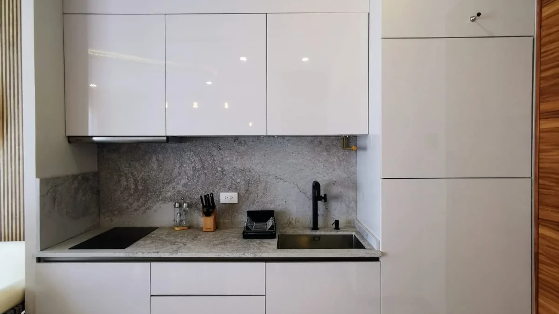 View of Modern Kitchenette at Alizee, showcasing Compact Kitchen, White Cabinets.