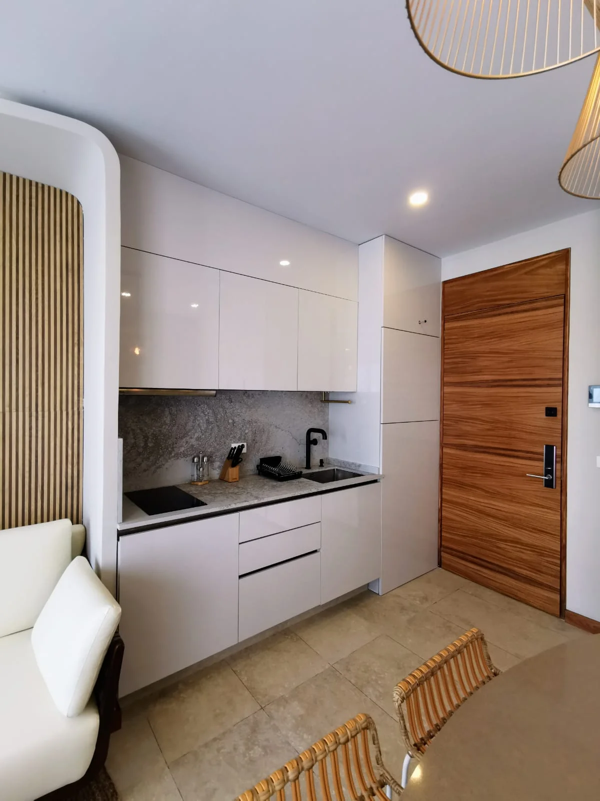 View of Modern Kitchenette at Alizee, showcasing Compact Living, White Cabinets.