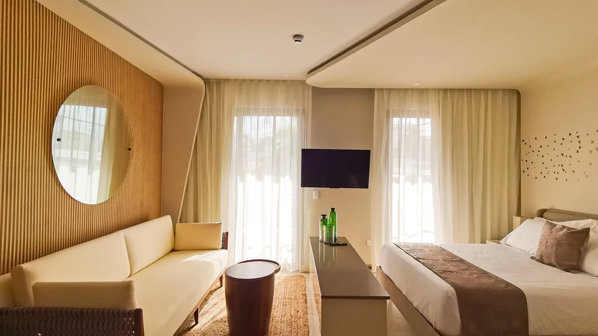 View of Modern Bedroom at Alizee, showcasing Studio Apartment, Wood Accent Wall.