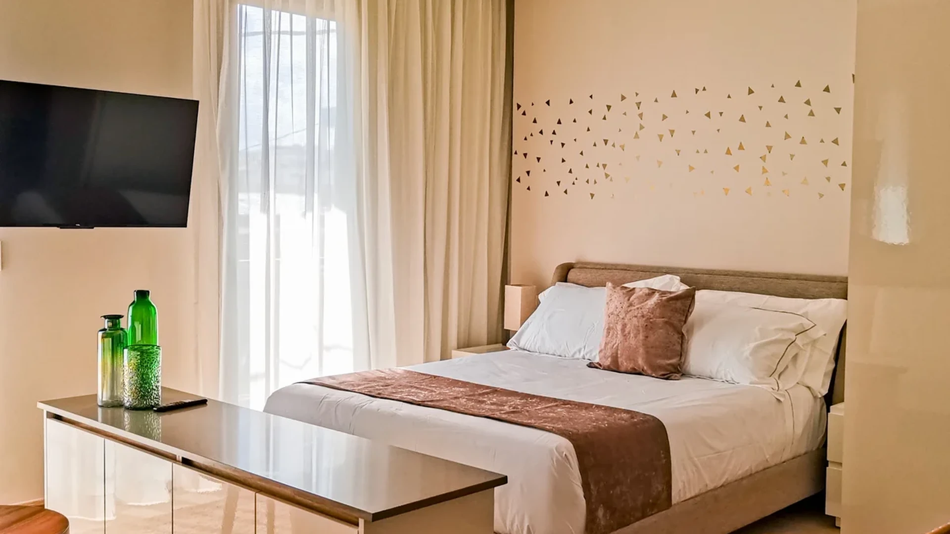 View of Modern Bedroom at Alizee, showcasing Natural Light, Neutral Decor.
