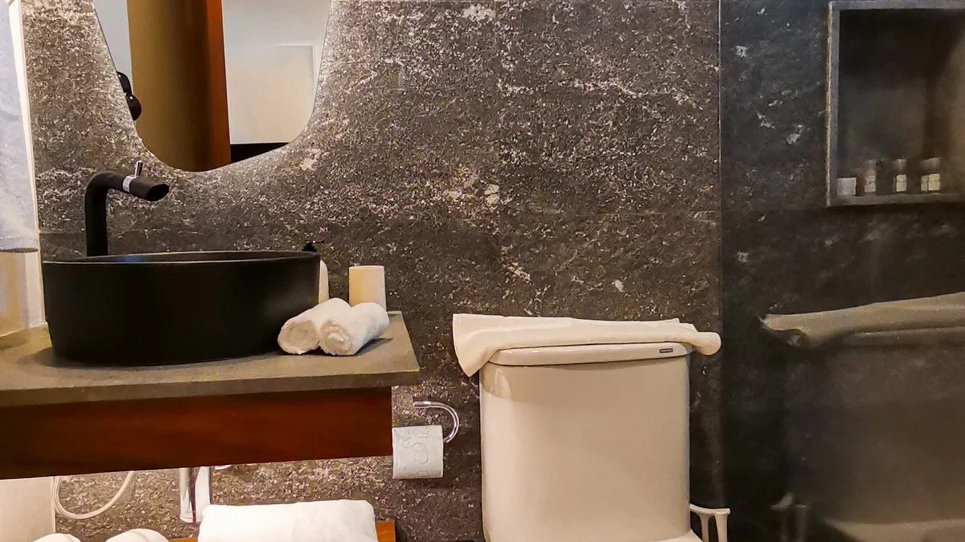 View of Modern Bathroom at Alizee, showcasing Stone Tile Wall, Vessel Sink.