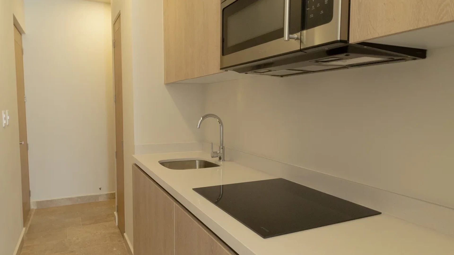 View of Kitchenette at Vibbe, showcasing Modern Kitchen, Wood Cabinetry.