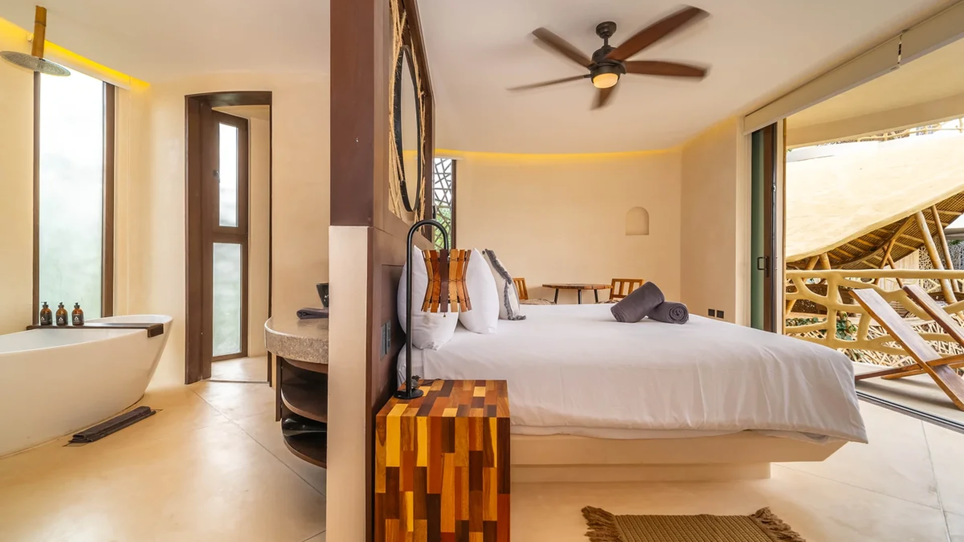 View of Luxury Bedroom at Kan Tulum, showcasing Open Concept Bathroom, Freestanding Tub.