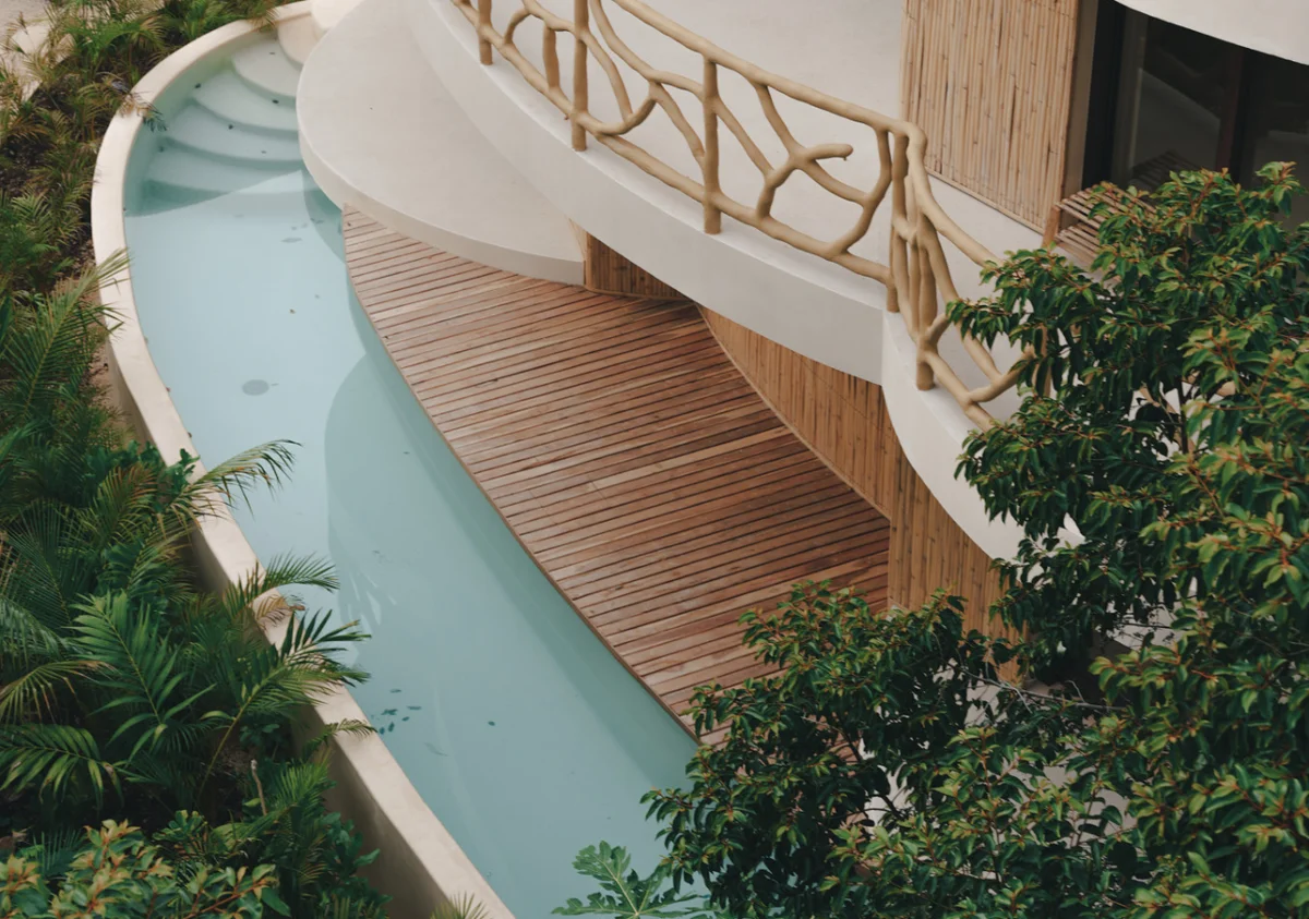 Image of Swimming Pool at Kan Tulum, featuring Tropical Architecture, Curved Pool Design.
