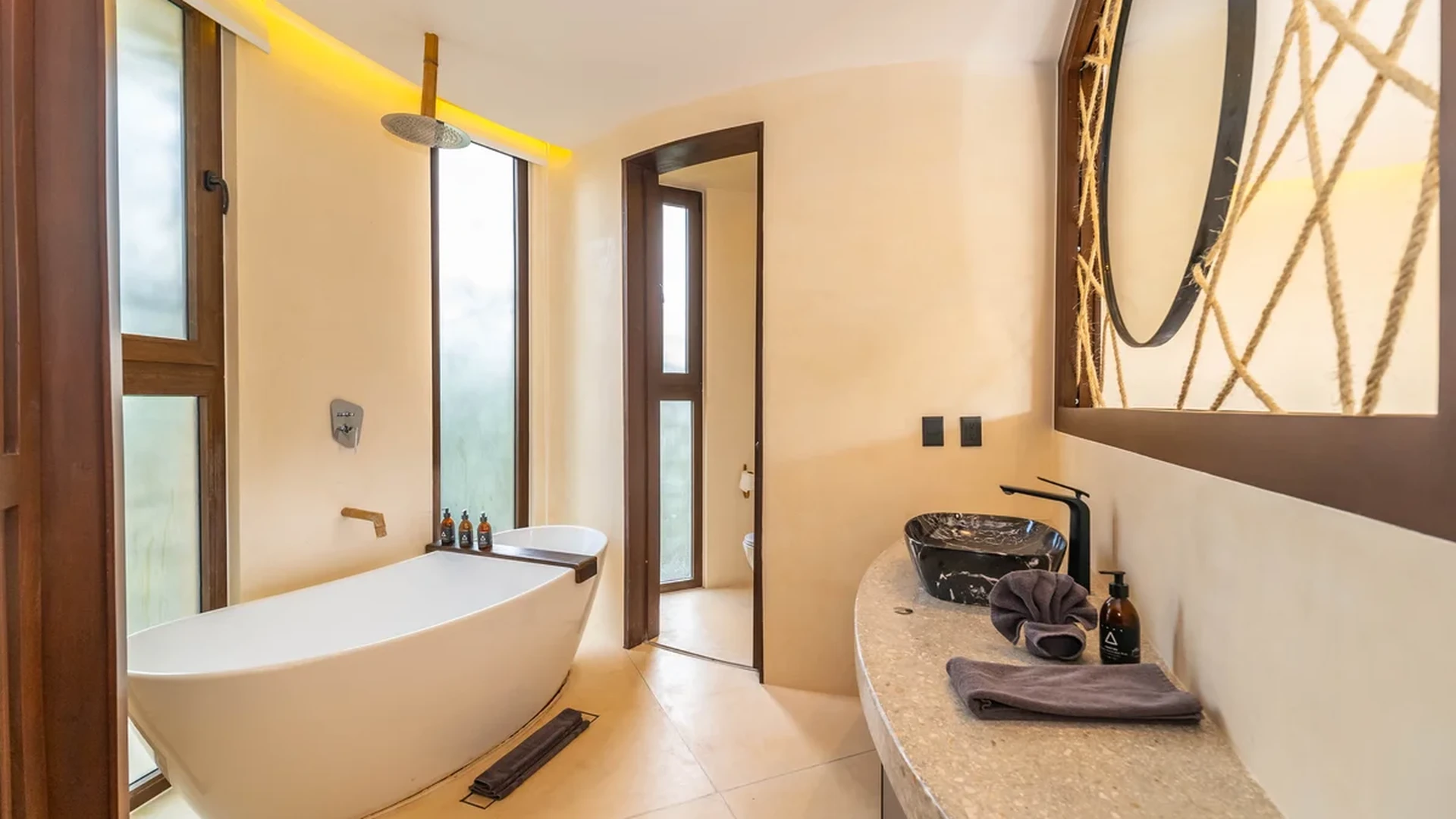 View of Modern Bathroom at Kan Tulum, showcasing Freestanding Tub, Rain Shower.